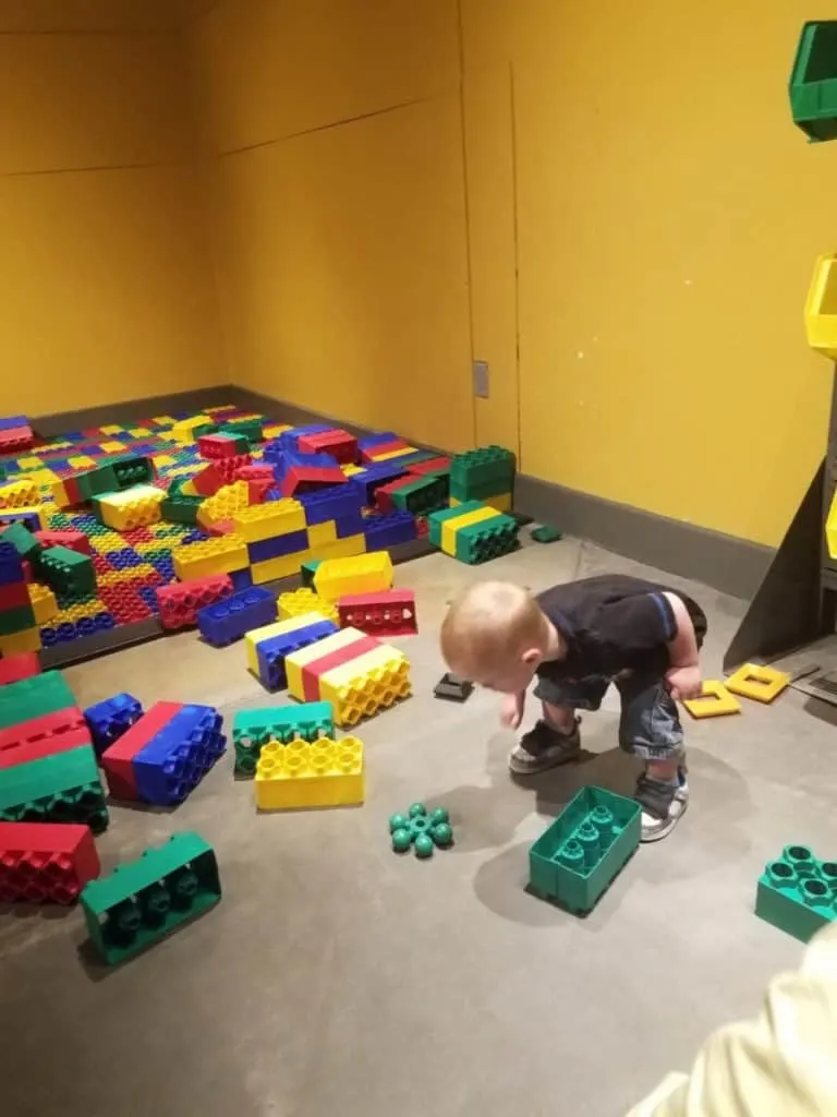 Educational Thanksgiving Point Activities and Events 7 Kid building with giant Legos at Kidopolis at Museum of Natural Curiosity at Thanksgiving Point in Lehi, UT
