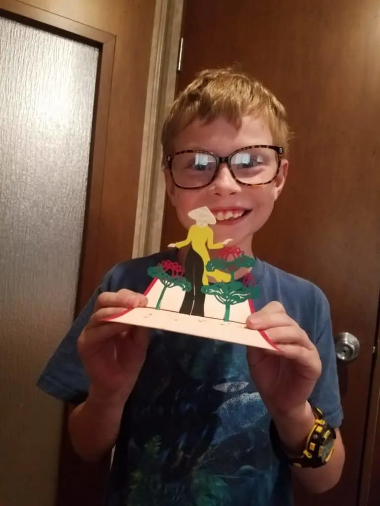 How to Easily Take Virtual Field Trips Around The World 6 Homeschooled boy with popup postcard of Taiwan from The Adventurous Mailbox