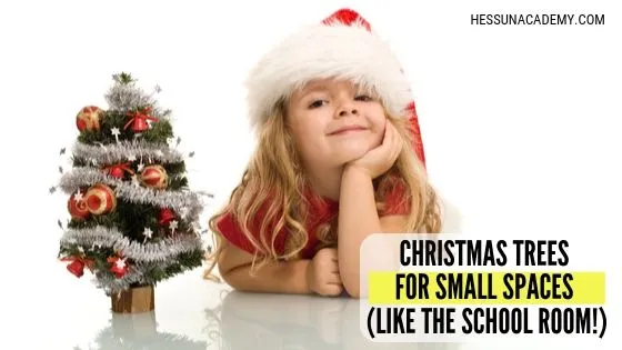 Little Girl by a small Christmas tree ready for Christmas in a small space.