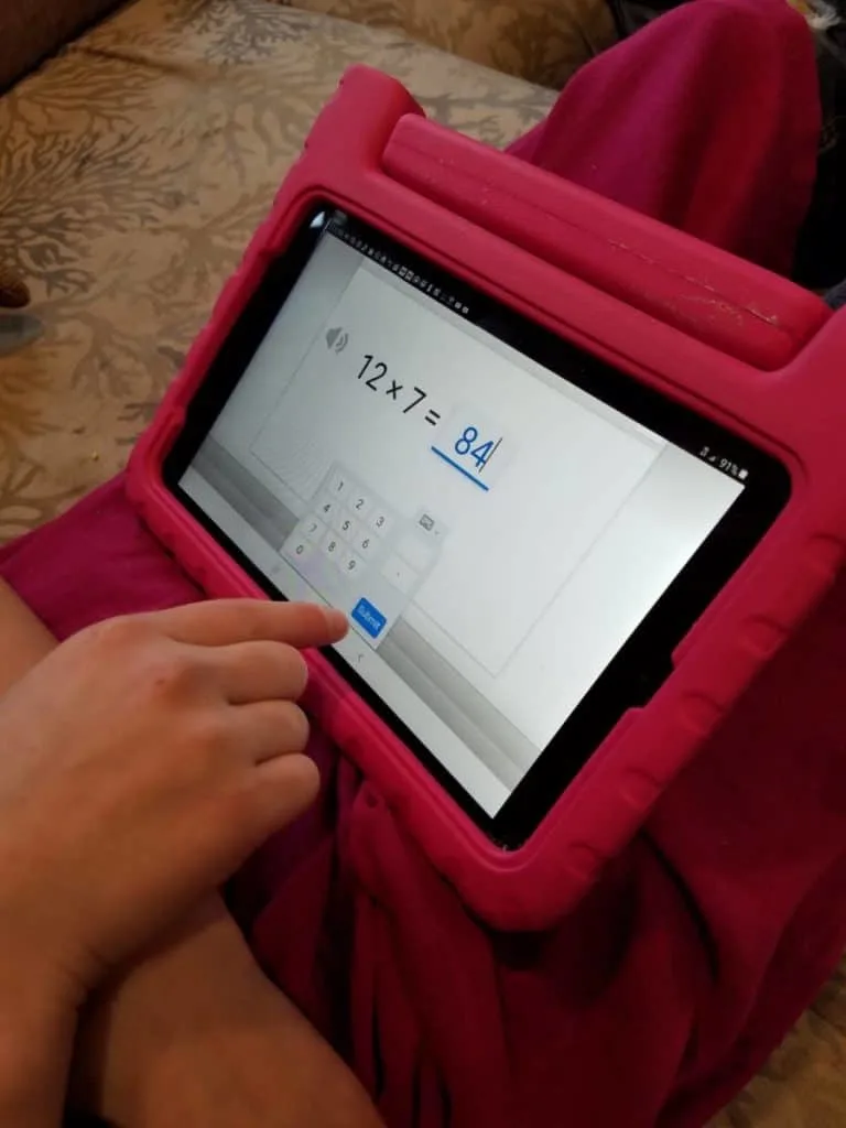 Is CTCMath Best Online Math Curriculum for Homeschoolers? 6 Homeschooled girl taking basic math lessons on a pink tablet with CTCMath