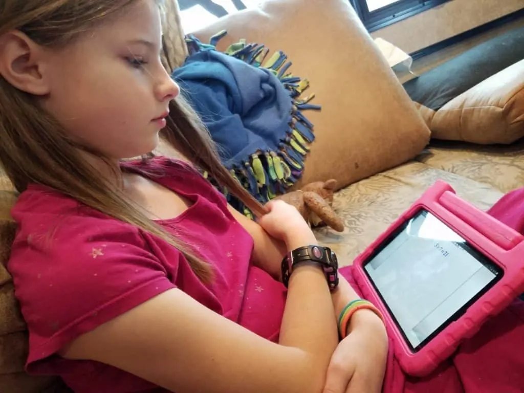 Is CTCMath Best Online Math Curriculum for Homeschoolers? 4 Young homeschooled girl in pink dress doing basic math lessons on a pink tablet with CTCMath