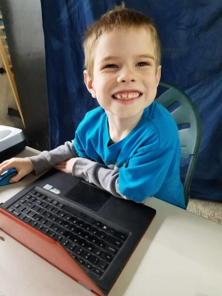 Is CTCMath Best Online Math Curriculum for Homeschoolers? 5 Happy homeschooled boy doing CTCMath lessons on the laptop