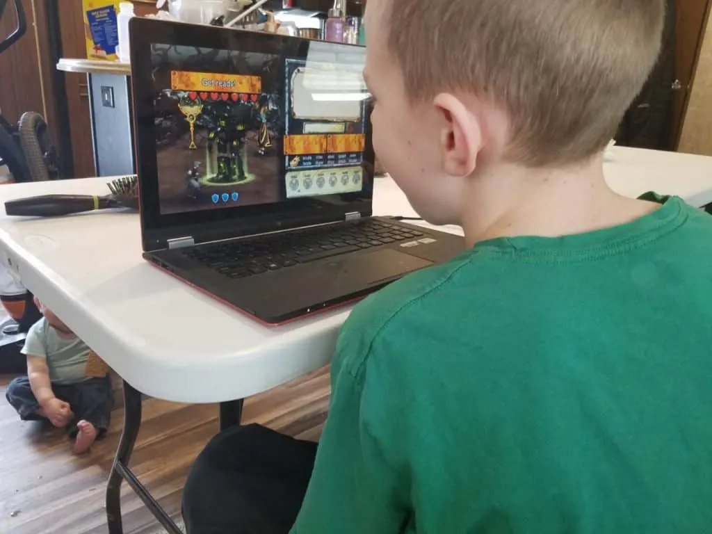 How to Enjoy Fun Vocabulary Games with Vocabulary Quest 5 Young boy playing a fun vocabulary video game and fighting monsters in Vocabulary Quest