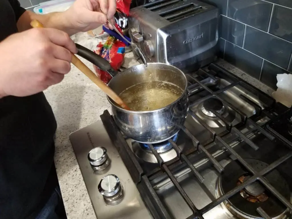 Rock Candy Science Experiment: Step-by-Step How-To Guide 5 Making homemade rock candy over the stove for a homeschool science fair project
