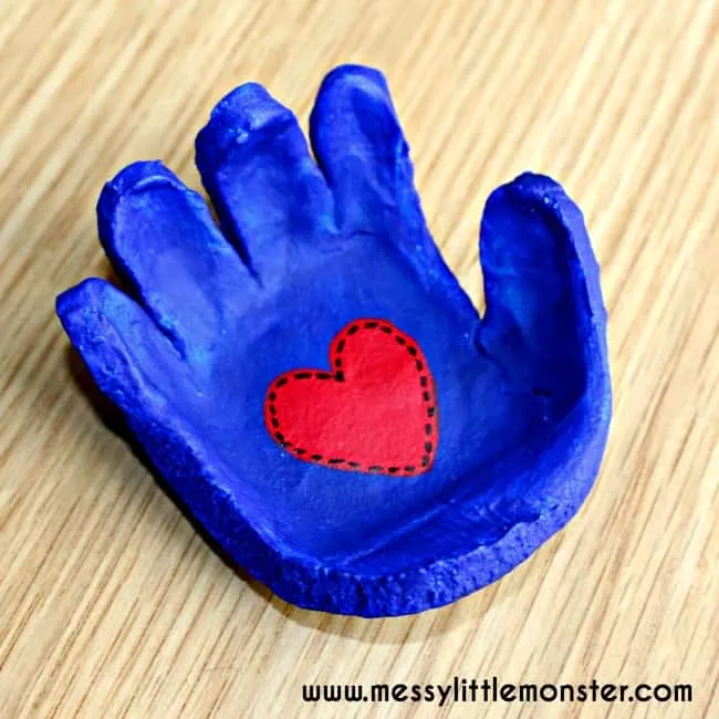 11 Cheap Mother's Day Gift Ideas 5 blue salt dough handprint basket with a red heart for a cheap Mother's Day gift idea