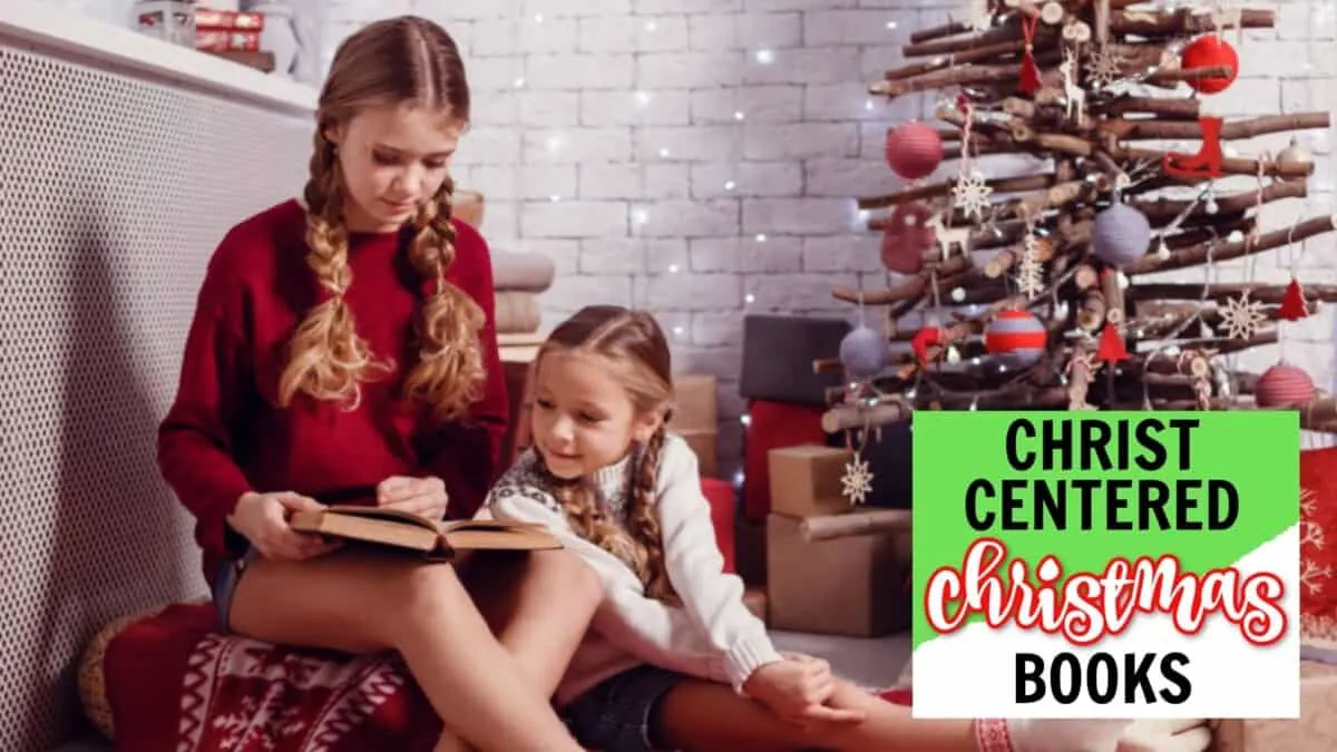 two little girls sitting by a Christmas tree reading a Christ-centered Christmas book for kids