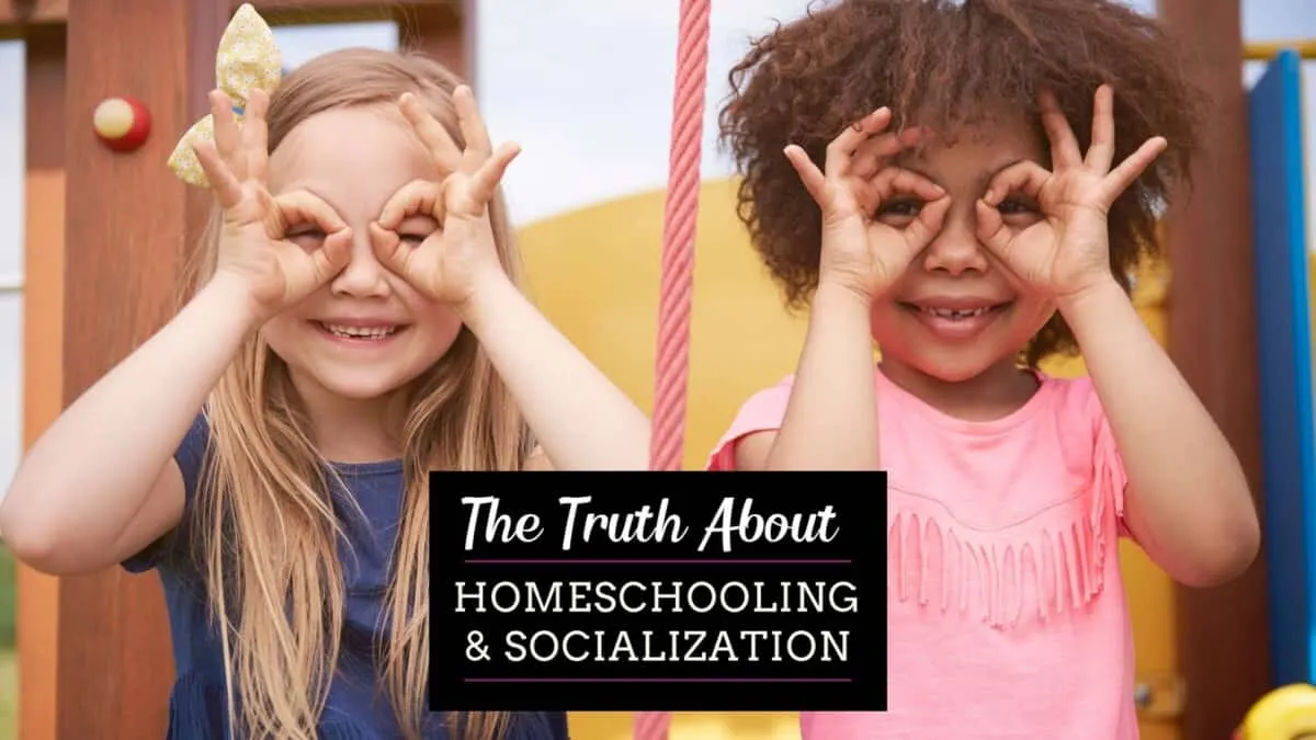 Two little homeschooled girls making finger binoculars enjoying homeschool socialization
