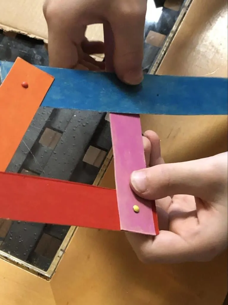 Chomping Cardboard Dragon STEAM Craft for Kids 11 criss-crossing cardboard strips for chomping dragon