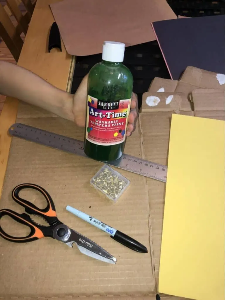 Chomping Cardboard Dragon STEAM Craft for Kids 4 paint, scissors, marker, cardboard, and other materials needed for a chomping cardboard dragon craft