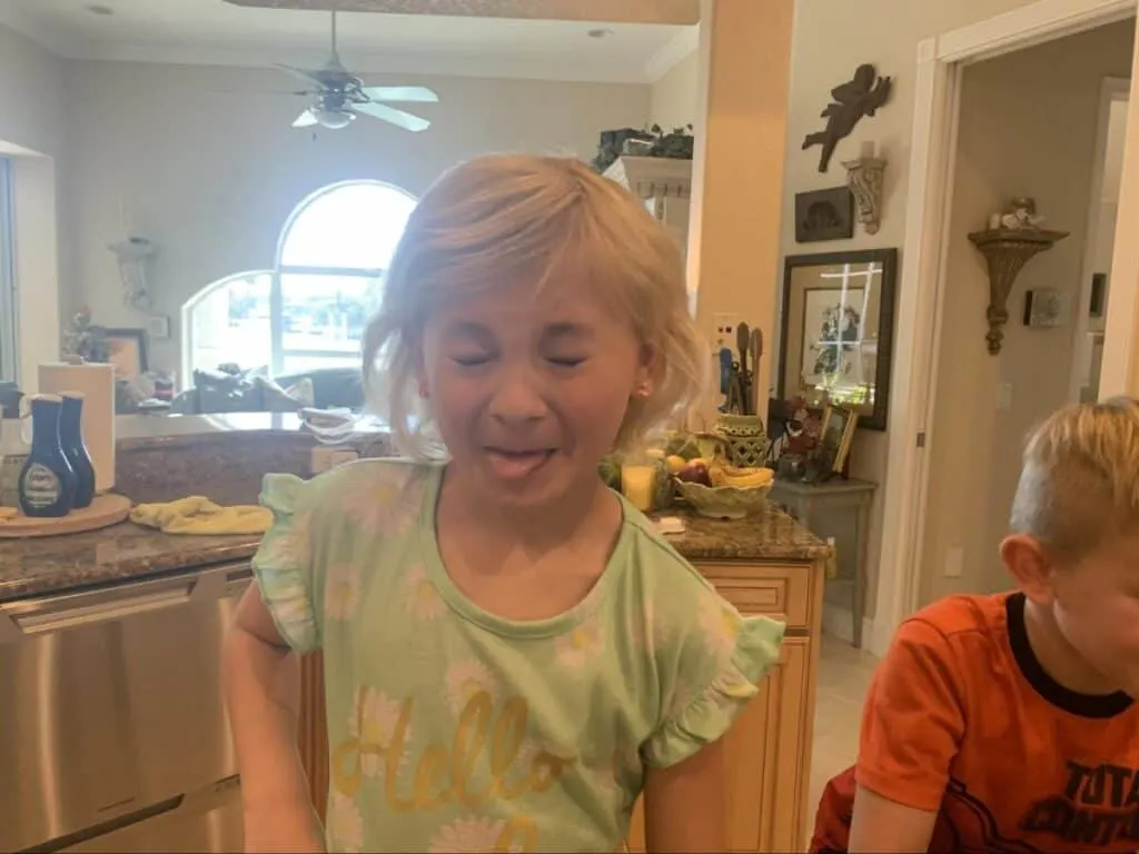 Fizzy Lemonade Edible Science Experiment 6 little girl making a face after enjoying her fizzy lemonade edible science experiment
