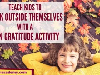 Little girl laying in some leaves smiling about her fun gratitude activity