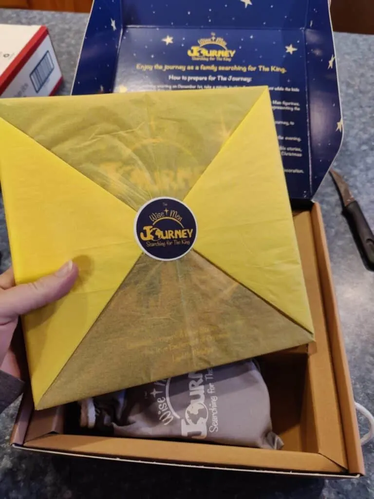 6+ Christian Alternatives to Elf on the Shelf 3 A Wise Men Journey Christmas countdown children's book wrapped in yellow tissue paper