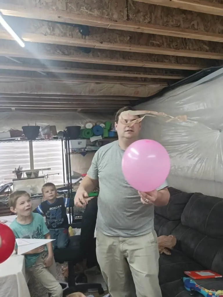 Static Electricity Experiment for Kids - Tame a Dragon with Magic 6 kids watching a man make a plastic dragon fly using a balloon and static electricity