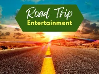 beautiful road at sunset with the sign road trip entertainment