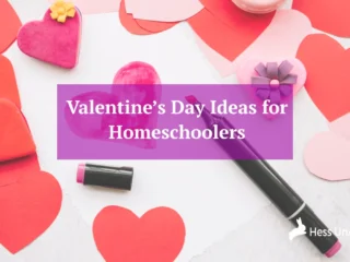 A flat lay of Valentine’s Day printables with heart decorations.